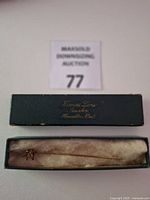 Stick pin in open jeweler’s box showing full length