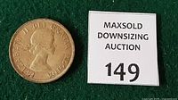 Obverse of 1958 Canadian silver dollar beside lot tag