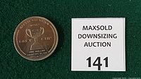 Obverse of token beside lot number card