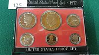 Front view of proof set showing obverse of six coins in case