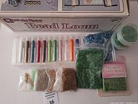 Boxed White Rose bead loom with tubes of seed beads and bags of beads laid out