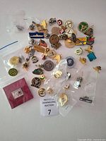 Spread of approx. 50 assorted lapel pins, some bagged
