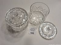 Both crystal dishes with lids shown, one lid removed