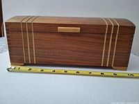 Front view of box with tape measure showing length