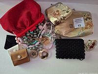 Group view of all purses, lipstick holder, and jewelry spread out