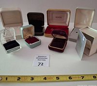 Eight assorted jewelry boxes open showing interiors
