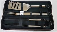 Open case showing all three stainless steel BBQ tools secured inside