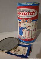 Tinkertoy Junior drum with lid off and instruction sheet visible