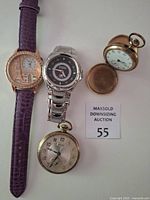 All four watches grouped: GoGoey wristwatch left, Fossil Blue wristwatch center, Elgin pocket watch right, Gruen pocket watch bottom