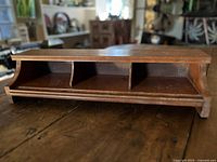 Front angled view showing three compartments and curved sides