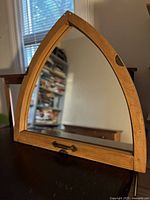 Front view of pointed arch wood mirror showing frame, glass, bottom pull handle