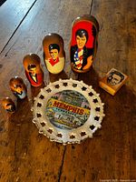 Full lot: five Elvis nesting dolls, Memphis plate, wooden Elvis stamp