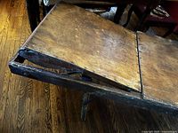 Top view of angled hinged segment showing worn wood surface and missing corner