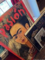 Large Pasión poster with other items stacked
