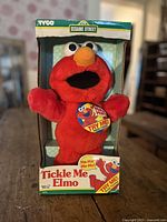 Front view of boxed Tickle Me Elmo doll