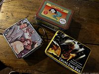 Three metal lunchboxes showing overall designs and handles