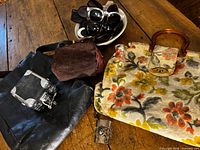 Group shot of all items: two handbags, coin purse, camera, sunglasses, bracelet