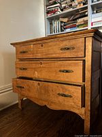 Front view showing three drawers, hardware and wear