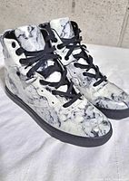 Oblique front view of both Balenciaga marble sneakers