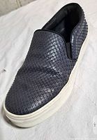 Left lateral view of single sneaker showing snakeskin upper and sole