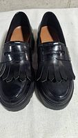 Top view of loafers showing fringe and leather condition