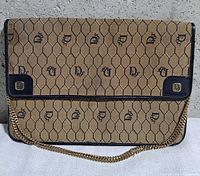 Front view showing Toile Grillage pattern, flap, chain strap