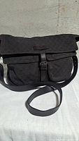 Front view of Gucci GG denim messenger bag with flap closed