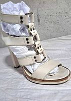 Left side view showing strappy design, heel and front platform