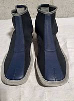 Front view of both booties showing leather and nylon uppers