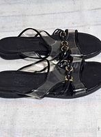 Top view of both sandals showing PVC uppers, patent straps and chain detail