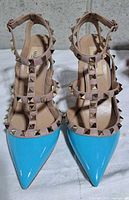 Top view showing pointed blue toes, beige studded straps, Valentino branding on insoles