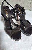 Oblique view showing both sandals, T-strap design, platform and logo insoles