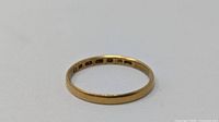 Side view of gold band showing hallmarks
