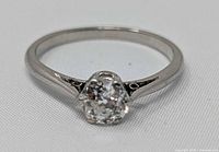 Top view of platinum solitaire ring showing diamond and six-prong setting