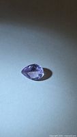 Pear-shaped amethyst, side angle showing facets and color