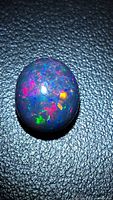Top view of the Ethiopian black fire opal showing multicolour play-of-colour