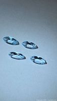 Four sky blue marquise topaz gemstones on neutral background