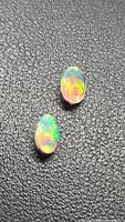 Both opals showing multicolour fire