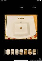 Top view showing KOHLER white sink with three faucet holes, overflow, centered drain