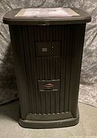 Front view of brown AIRCARE EP9800 pedestal humidifier showing digital control panel and logo