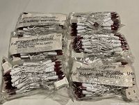 Six sealed packs of red LED mini lights on white wire