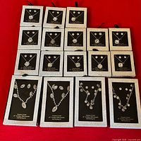 Front view showing all 17 boxed crystal necklace and earring sets