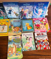 Overview of 14 books including Frozen titles, Rebus Treasury, assorted others