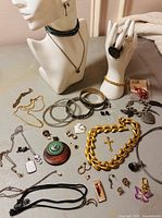 All items laid out showing variety of necklaces, bracelets, earrings, rings and charms
