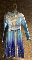 Front view of Elsa costume dress on hanger