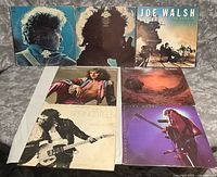 Seven album covers laid out, top and bottom rows