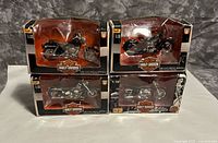 Front view of all four boxed Maisto Harley-Davidson models