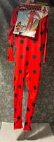 Full view of red polka-dot jumpsuit on hanger