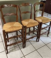 Three matching wood counter chairs full view