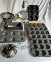 Group shot of all bakeware, mixer, strainers, rolling pin, measuring cup, steamer basket